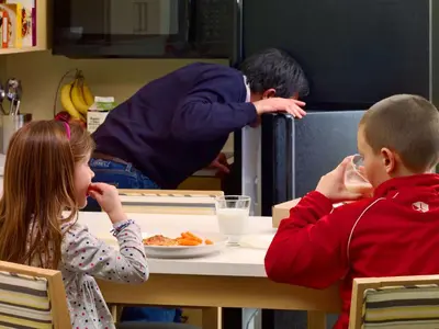 a boy and a girl sitting at a table eating food at Sonesta ES Suites Cincinnati - Blue Ash in Blue Ash