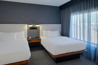a hotel room with two beds and a window at Courtyard Dayton South Mall in Miamisburg
