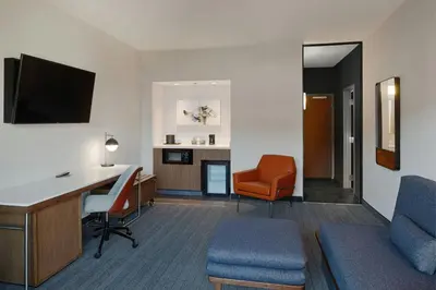 a hotel room with a desk and a chair at Courtyard Dayton South Mall in Miamisburg