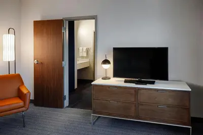 a room with a flat screen tv on a dresser at Courtyard Dayton South Mall in Miamisburg
