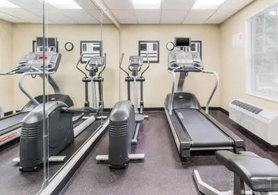 a gym with rows of treadmills and machines at Birch Hills Suites - Blue Ash in Blue Ash