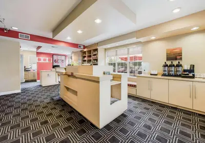 a large kitchen with a counter in a store at Birch Hills Suites - Blue Ash in Blue Ash