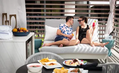 a man and woman sitting on a chair on a patio at Marriott Lexington Griffin Gate Golf Resort & Spa in Lexington
