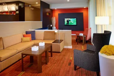 a living room with a couch and a table at Courtyard by Marriott Lexington North in Lexington