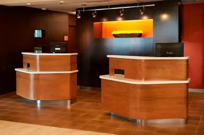 a lobby with wooden counters and a painting on the wall at Courtyard Toledo Airport Holland in Holland