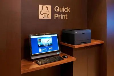 a desk with a computer and a printer on it at Courtyard Toledo Rossford/Perrysburg in Rossford