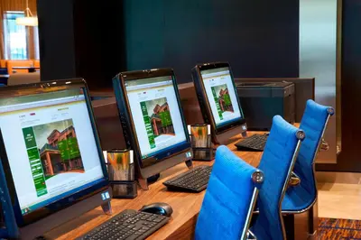 a table with four laptop computers on it at Courtyard Toledo Rossford/Perrysburg in Rossford