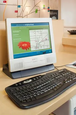 a computer monitor and a keyboard on a desk at TownePlace Suites by Marriott Findlay in Findlay