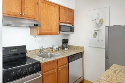 a kitchen with a sink and a stove and a refrigerator at TownePlace Suites by Marriott Findlay in Findlay