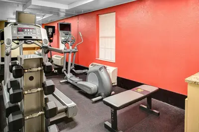 a gym with red walls and a tread machine at TownePlace Suites by Marriott Findlay in Findlay