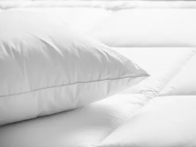 a white pillow sitting on top of a bed at Columbus Airport Marriott in Columbus