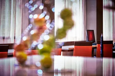 a dining room with red chairs and a glass table at Columbus Airport Marriott in Columbus