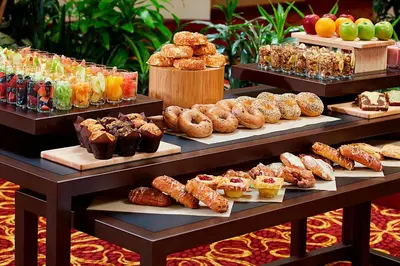 a display case with different types of pastries and desserts at Columbus Airport Marriott in Columbus