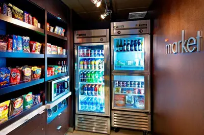 a refrigerator in a store with lots of drinks at Courtyard Columbus Airport in Columbus