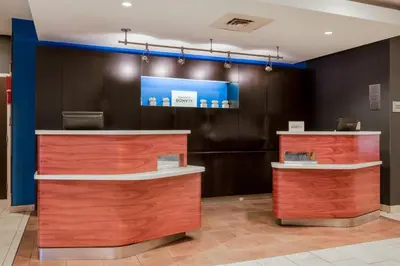 a lobby of a dental office with wooden counters at Courtyard Columbus Airport in Columbus