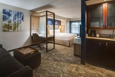 a hotel room with a bed and a desk at SpringHill Suites Dayton South/Miamisburg in Miamisburg