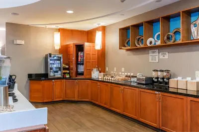 a large kitchen with wooden cabinets and a counter top at SpringHill Suites Dayton South/Miamisburg in Miamisburg