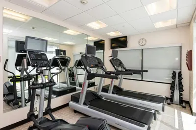 a gym with treadmills and ellipticals in a room at SpringHill Suites Dayton South/Miamisburg in Miamisburg