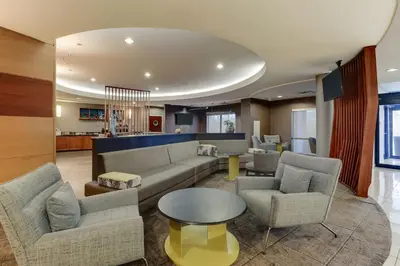 a living room with a couch and chairs and a table at SpringHill Suites Dayton South/Miamisburg in Miamisburg