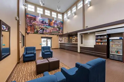 a waiting room with blue chairs and a lobby at Comfort Suites Columbus Expo Center in Columbus