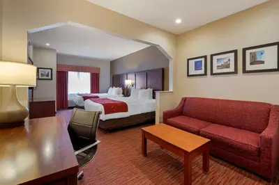 a hotel room with a bed and a couch at Comfort Suites Columbus Expo Center in Columbus