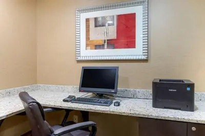 a desk with a computer monitor and a printer at Comfort Suites Columbus Expo Center in Columbus