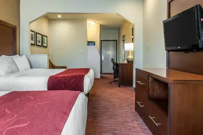 a hotel room with two beds and a flat screen tv at Comfort Suites Columbus Expo Center in Columbus