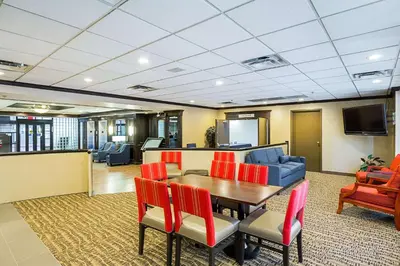 a conference room with a table and chairs and a tv at Comfort Inn Cleveland Downtown in Cleveland
