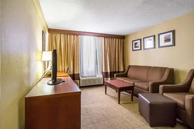 a hotel room with a couch and a living room at Comfort Inn Cleveland Downtown in Cleveland