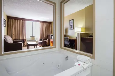 a hotel room with a tub and a living room at Comfort Inn Cleveland Downtown in Cleveland
