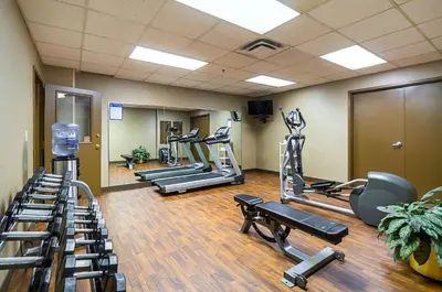 a gym with several treadmills and cardio machines at Comfort Inn Cleveland Downtown in Cleveland