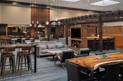 a lobby of a hotel with tables and chairs at Cleveland Marriott East in Warrensville Heights