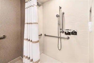 a bathroom with a shower with a shower curtain at Cleveland Marriott East in Warrensville Heights