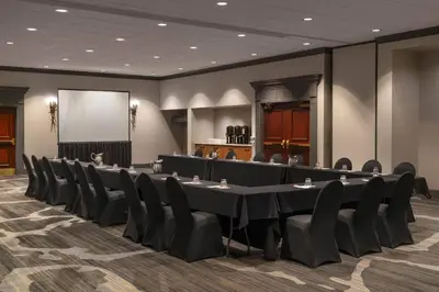 a conference room with a long table and chairs at Cleveland Marriott East in Warrensville Heights