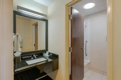 a bathroom with a sink and a mirror at Quality Inn & Suites Sandusky in Sandusky
