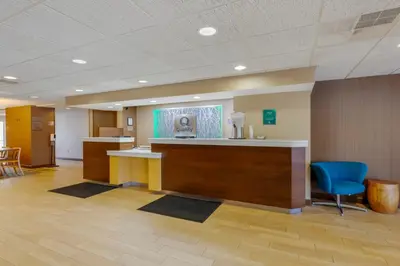 a lobby of a hospital with a reception desk and chairs at Quality Inn & Suites Sandusky in Sandusky