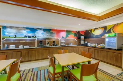 a fast food restaurant with tables and a kitchen at Quality Inn & Suites Sandusky in Sandusky