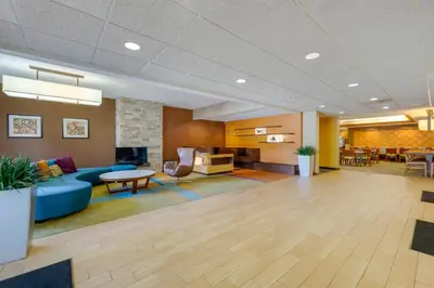 an office lobby with a blue couch and a table at Quality Inn & Suites Sandusky in Sandusky