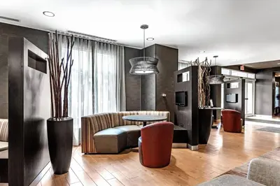 a living room with a table and a couch at Courtyard Columbus Easton in Columbus