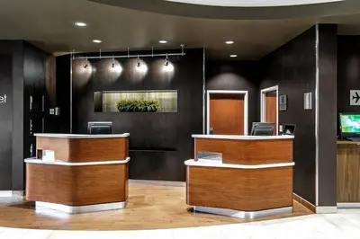 a lobby with a reception desk and a television at Courtyard Columbus Easton in Columbus