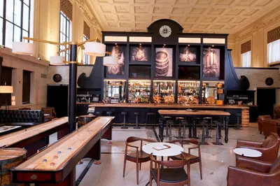 a restaurant with tables and chairs and a bar at Residence Inn Columbus Downtown in Columbus