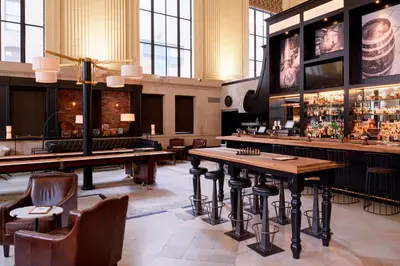 a restaurant with a bar with tables and chairs at Residence Inn Columbus Downtown in Columbus