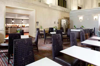 a restaurant with tables and chairs and a kitchen at Residence Inn Columbus Downtown in Columbus