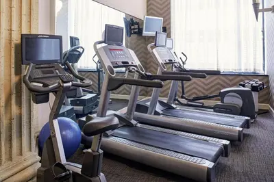 a gym with several tread machines and a laptop on a treadmill at Residence Inn Columbus Downtown in Columbus