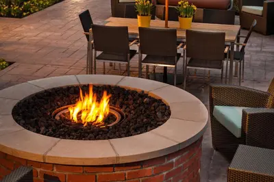 a fire pit in a patio with chairs and a table at Residence Inn Columbus Easton in Columbus