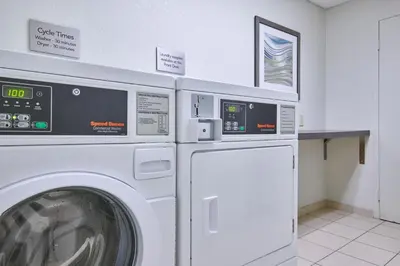 a laundry room with a washer and dryer at Courtyard Columbus Downtown in Columbus