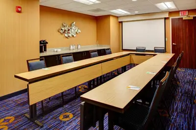 a conference room with tables and chairs and a whiteboard at Courtyard Columbus Downtown in Columbus