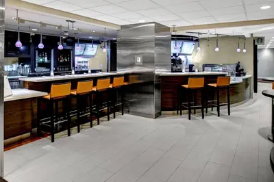 a bar in a restaurant with wooden bar stools at Courtyard Columbus Downtown in Columbus