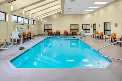 a large swimming pool with chairs and tables at Courtyard Columbus Downtown in Columbus