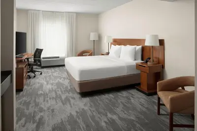 a hotel room with a large bed and a desk at Fairfield Inn & Suites Columbus OSU in Columbus